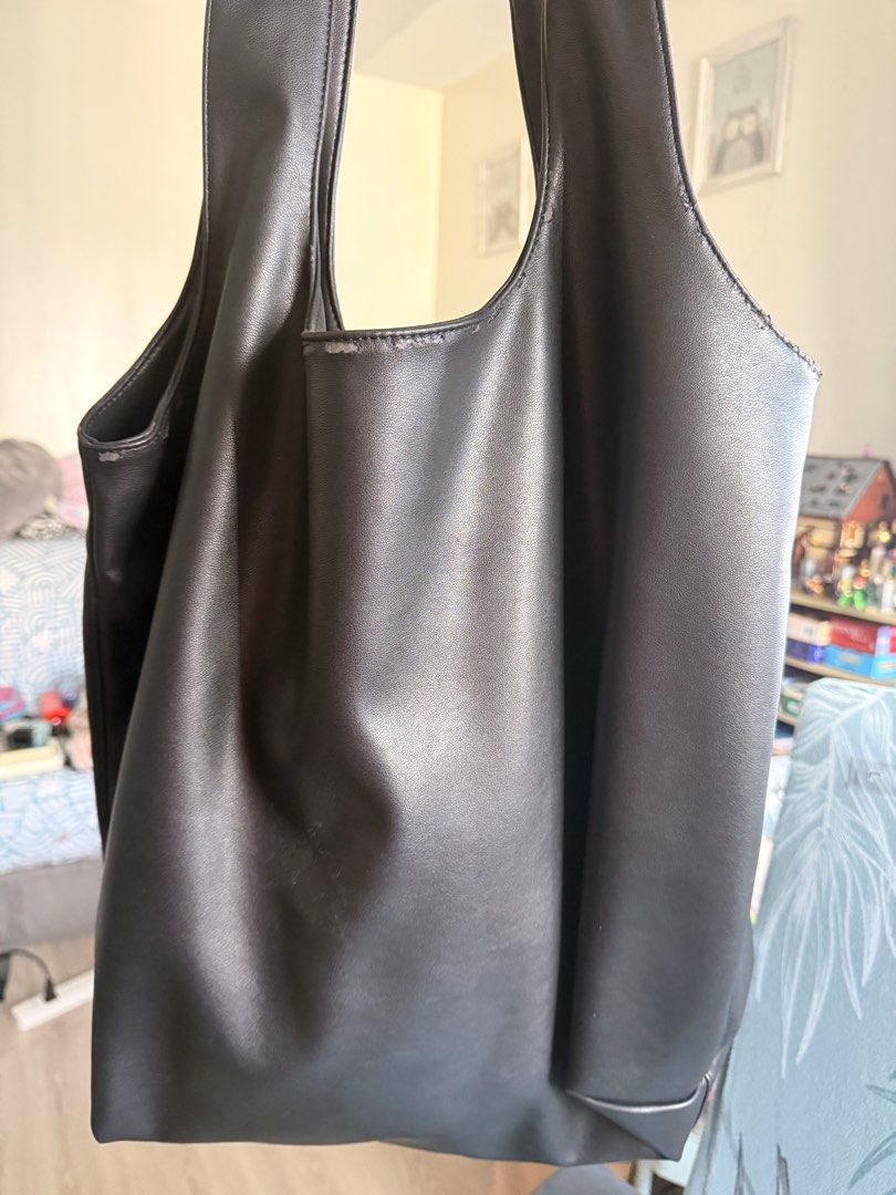 A.P.C. Ninon Black Leather Tote Bag (Category: Tote Bags) located in Quezon City. Submitted by charmerchant (Listing ID 1463222277, Image 3). Description: - Brand: A.P.C. - Material: Black Leather - Style: Tote Bag Black Large size With minor peeling on shoulder straps but not very visible especially when worn.