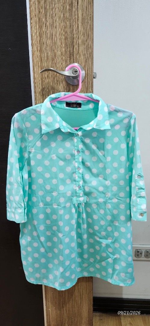 Aqua Polka Dot Button-Up Shirt (Category: Blouses) located in Manila. Submitted by atan2025 (Listing ID 1463219602, Image 1). Description: - Aqua shirt with white polka dots - Button-up front with collar - Long sleeves with button cuffs - Lightweight material - Ideal for casual wear or layering - Brand: Vicki.