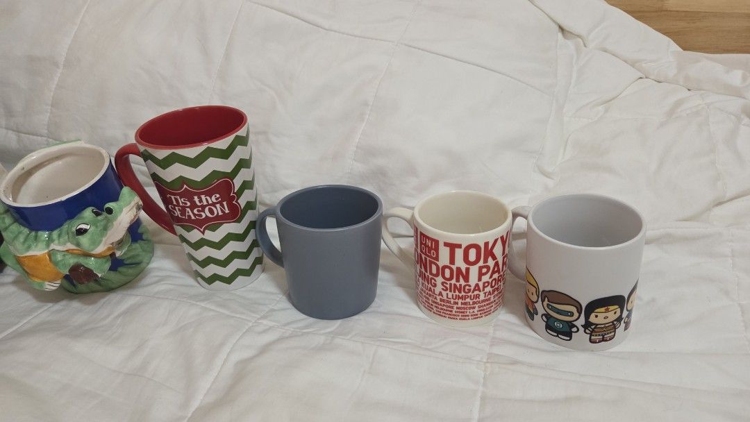 Assorted Ceramic Mugs SUPER SALE (Category: Coffee & Tea Tableware) located in Bacoor. Submitted by nahalili1 (Listing ID 1463185591, Image 2). Description: Bundle of 5 preloved mugs - Vintage crocodile mug - "Tis the season" Christmas mug - Solid color blue/cobalt mug - Uniqlo store opening mug - Chibi DC Justice League mug RFS: downsizing my collection - Some mugs have a name tag at the bottom but it can be washed off - Price negotiable.