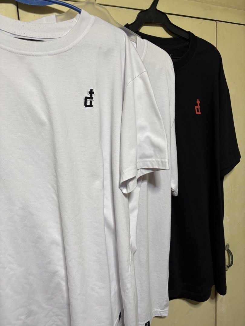 Assorted DGrave Graphic T-shirts - White & Black (Category: Tshirts & Polo Shirts ) located in Quezon City. Submitted by denmarkkno44009 (Listing ID 1463222931, Image 2). Description: - All Large (W 23) (L 29) - Set of 3 graphic t-shirts - Two white tees with unique embroidered logos - One black tee with a red embroidered logo - Classic short-sleeved, crew neck style - Versatile basics for any outfit - Available for individual purchase or as a bu