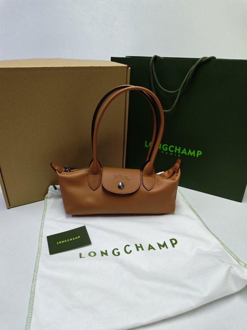 Authentic Longchamp Le Pliage Cuir Xtra Leather Bag (Category: Luxury Bags & Wallets) located in Quezon City. Submitted by hollowwillow (Listing ID 1463222595, Image 1). Description: - Authentic Longchamp top handle bag - Color: cashew - Material: Leather - 12"w top x 10" w base x 5" h x 3" d inches.