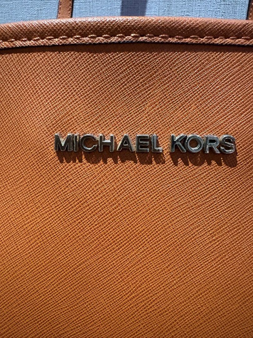 Authentic Michael Kors Orange Leather Tote Bag (Category: Luxury Bags & Wallets) located in Manila. Submitted by foundhouseph (Listing ID 1463295679, Image 3). Description: - Authentic Orange Michael Kors tote bag - Genuine saffiano leather - Gold tone hardware - Interior zip pocket and slip pocket - Minor wear on top edge stitching - Ideal everyday bag.