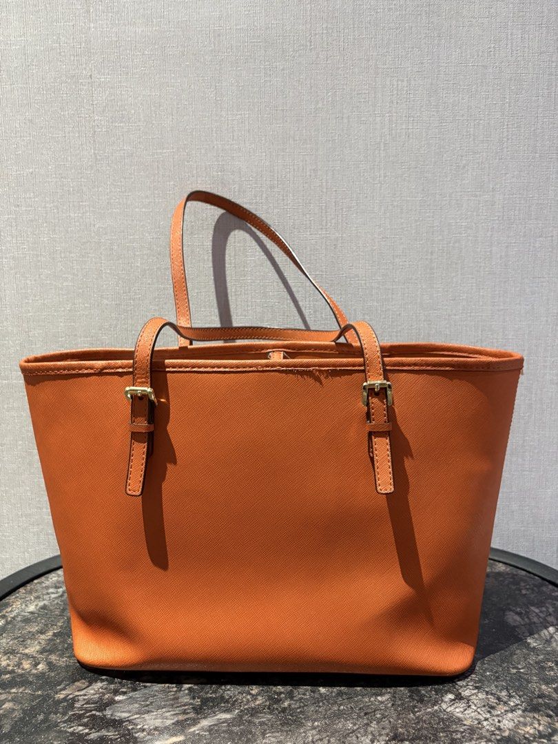 Authentic Michael Kors Orange Leather Tote Bag (Category: Luxury Bags & Wallets) located in Manila. Submitted by foundhouseph (Listing ID 1463295679, Image 2). Description: - Authentic Orange Michael Kors tote bag - Genuine saffiano leather - Gold tone hardware - Interior zip pocket and slip pocket - Minor wear on top edge stitching - Ideal everyday bag.
