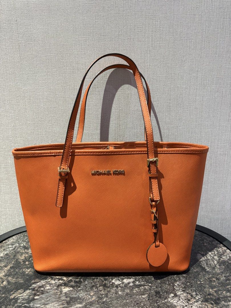 Authentic Michael Kors Orange Leather Tote Bag (Category: Luxury Bags & Wallets) located in Manila. Submitted by foundhouseph (Listing ID 1463295679, Image 1). Description: - Authentic Orange Michael Kors tote bag - Genuine saffiano leather - Gold tone hardware - Interior zip pocket and slip pocket - Minor wear on top edge stitching - Ideal everyday bag.