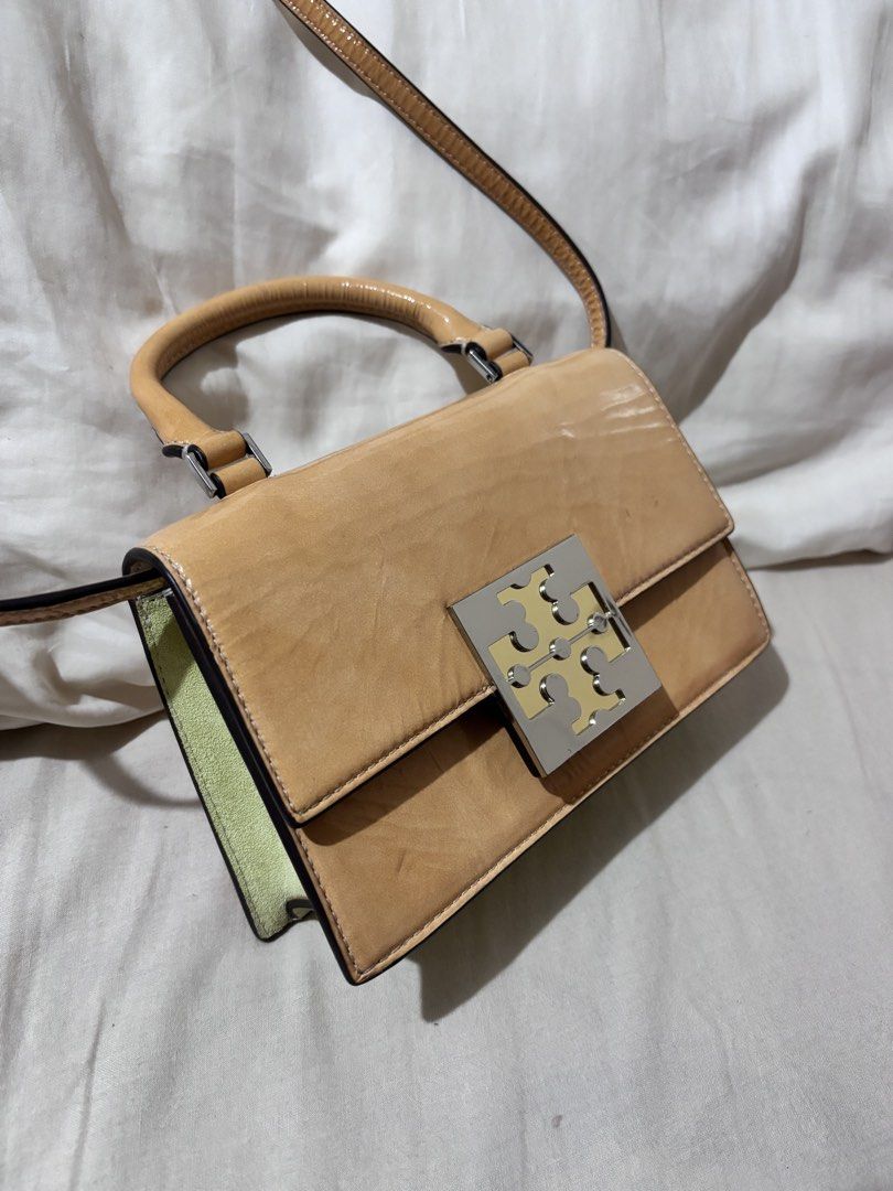 Authentic Tory Burch Mini Top Handle Bag in Shiny Leather (Category: Luxury Bags & Wallets) located in Valenzuela. Submitted by ven1se (Listing ID 1463273968, Image 2). Description: Authentic Tory Burch Leather Mini Top Handle Bag in Light Tan with silver tone logo clasp - Detachable Shoulder Strap and Interior Card Slots - No box RFS: Not in use MOP: GCash .