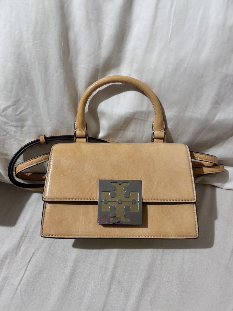 Authentic Tory Burch Mini Top Handle Bag in Shiny Leather (Category: Luxury Bags & Wallets) located in Valenzuela. Submitted by ven1se (Listing ID 1463273968, Image 1). Description: Authentic Tory Burch Leather Mini Top Handle Bag in Light Tan with silver tone logo clasp - Detachable Shoulder Strap and Interior Card Slots - No box RFS: Not in use MOP: GCash .