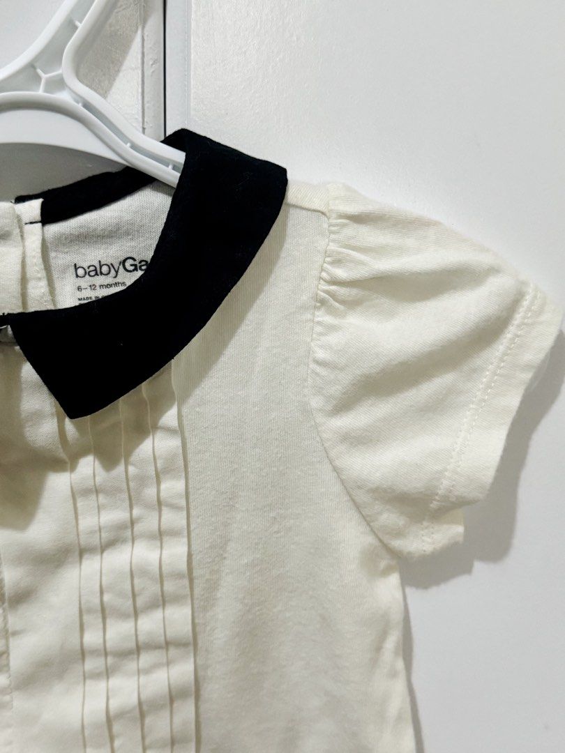 BabyGap White Top with Black Peter Pan Collar (Category: Babies & Kids Fashion) located in Cabanatuan. Submitted by floy_francisco (Listing ID 1463279711, Image 2). Description: - Brand: BabyGap - Size: 6-12 months - Color: White - Features: Black Peter Pan collar, puff short sleeves, pleated front detail - Style: Dressy or casual wear.
