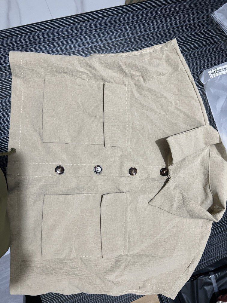 Beige Cropped Utility Top with Pockets (Category: Coats, Jackets and Outerwear) located in Las Pinas. Submitted by dhen.declutters (Listing ID 1463258010, Image 3). Description: - Cute beige cropped top - Short sleeves - Collared neckline - Two front pockets with button closures - Versatile for casual wear or layering - Pairs well with high-waisted bottoms.