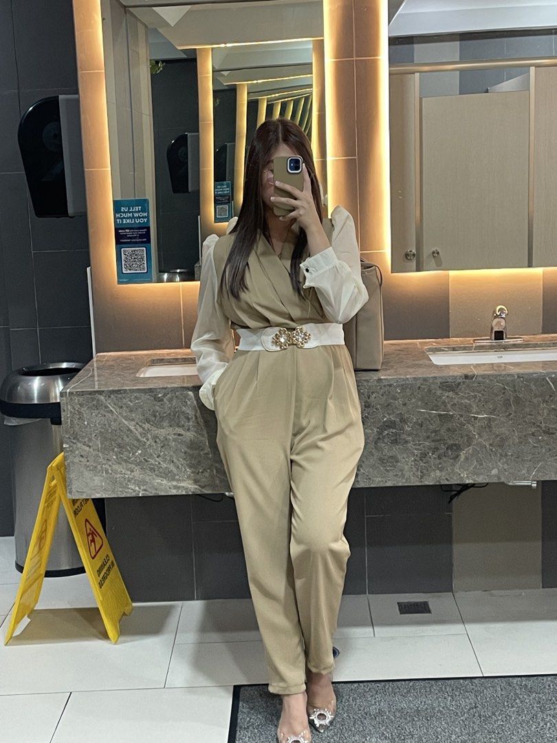 Beige Jumpsuit (Category: Jumpsuits) located in Pasig City. Submitted by jnmntmyr (Listing ID 1463201086, Image 1). Description: - Stylish beige jumpsuit - Contrasting white puff sleeves - Flattering wrap-style top - Comfortable wide-leg pants - Comes with a decorative white belt with gold accents - Ideal for night outs or special occasions - Belt not included - Also available in Black.