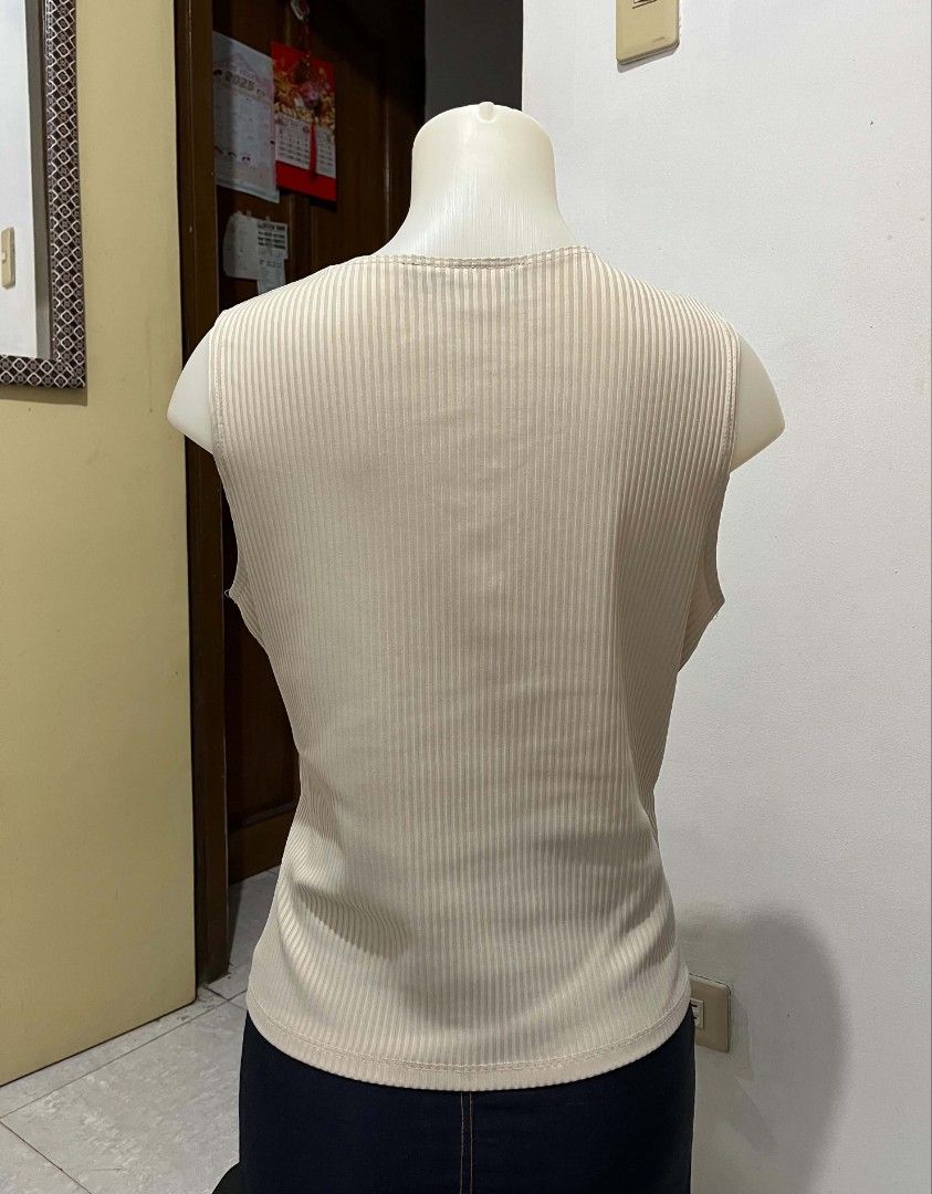 Beige Ribbed V-Neck Sleeveless Wrap Top (Category: Sleeveless) located in Quezon City. Submitted by syayayay (Listing ID 1463130536, Image 2). Description: - Sleeveless V-neck top - All-over ribbed texture - Flattering wrap-around front design - Bagay for corporate attire. Medyo maluwag sakin but in very good condition pa..