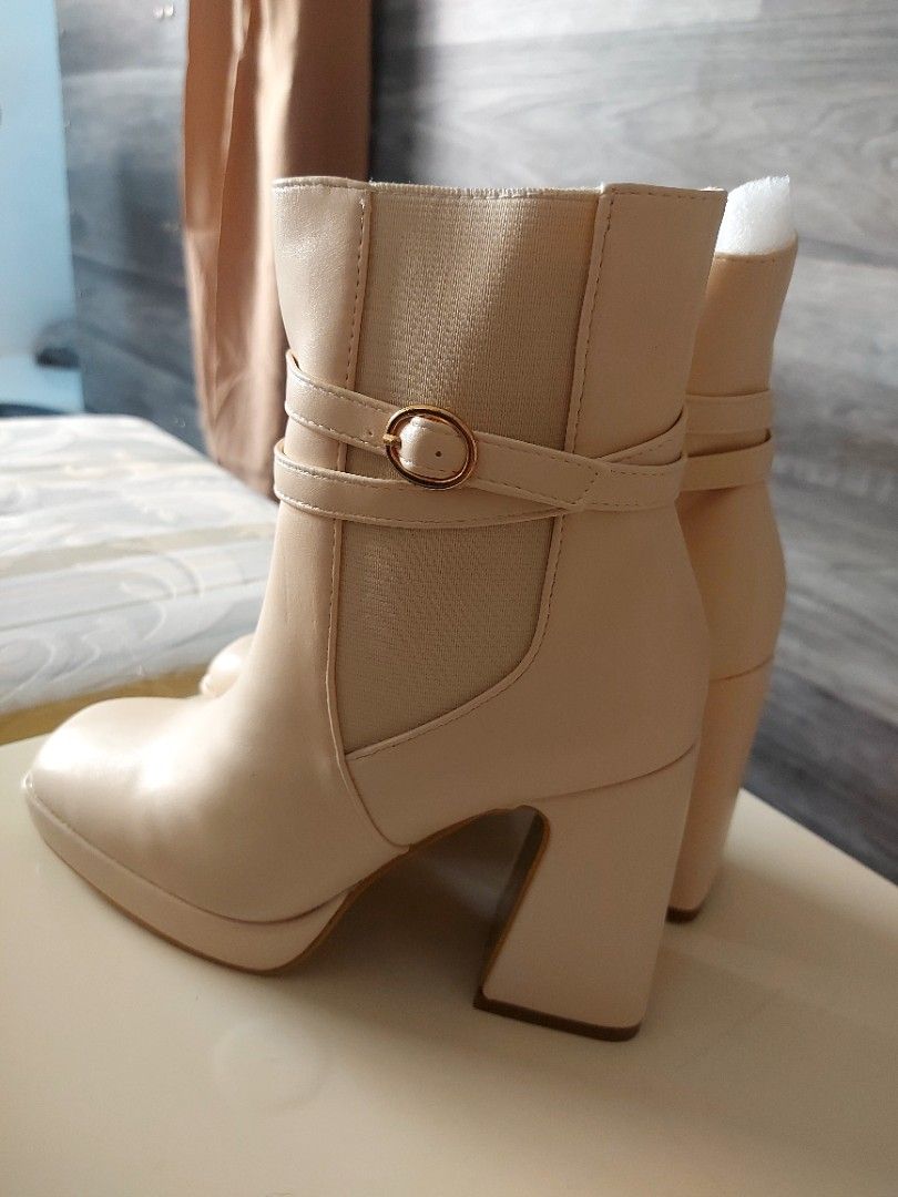 Beige Square Toe Block Heel Ankle Boots (Category: Boots) located in Paranaque City. Submitted by 28th_prelove (Listing ID 1463199036, Image 2). Description: - Beige ankle boots - Square toe and block heel - Side zipper closure - Decorative strap with gold buckle - Elastic panels on shaft for comfortable fit - Style: Perfect for dressing up or down.