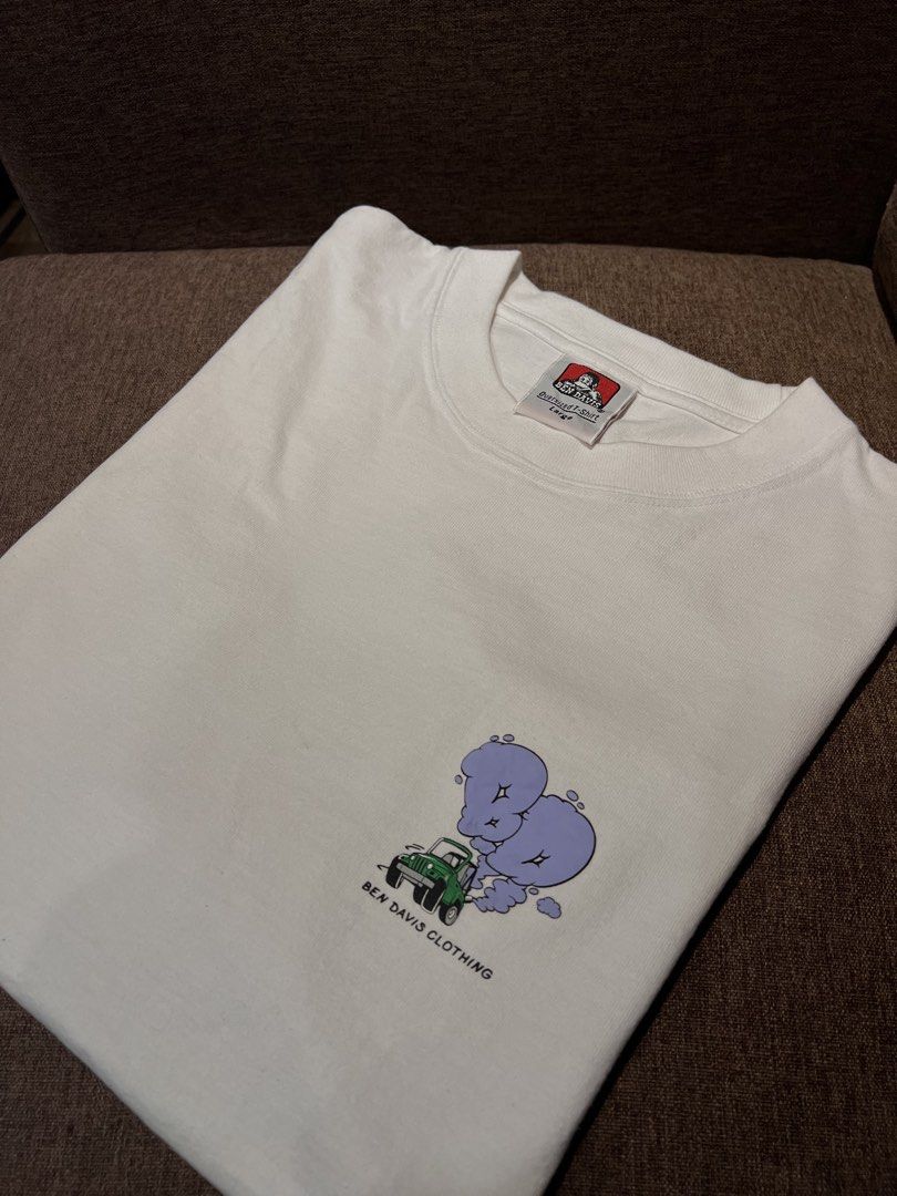 Ben Davis Oversized T-Shirt Large White Graphic Print (Category: Tshirts & Polo Shirts ) located in Manila. Submitted by wearurlux_wul (Listing ID 1463311258, Image 1). Description: - White Ben Davis oversized t-shirt - Size: Large (22x28) - Graphic print on front and back: green jeep with purple smoke - Comfortable material - Ideal for casual wear.