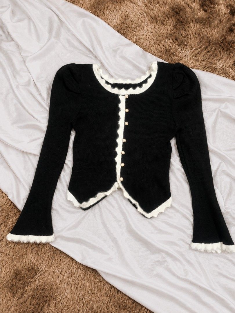 Black & White Trim Knit Cardigan (Category: Longsleeves) located in Manila. Submitted by dear.naiah (Listing ID 1463299851, Image 1). Description: •Classic black ribbed knit cardigan •Features delicate white ruffled trim on the neckline, front, hem & cuffs •Gold-tone button details for a feminine touch •Fitted silhouette with slightly flared sleeves •Perfect for a sweet, coquette-inspired or classy look.