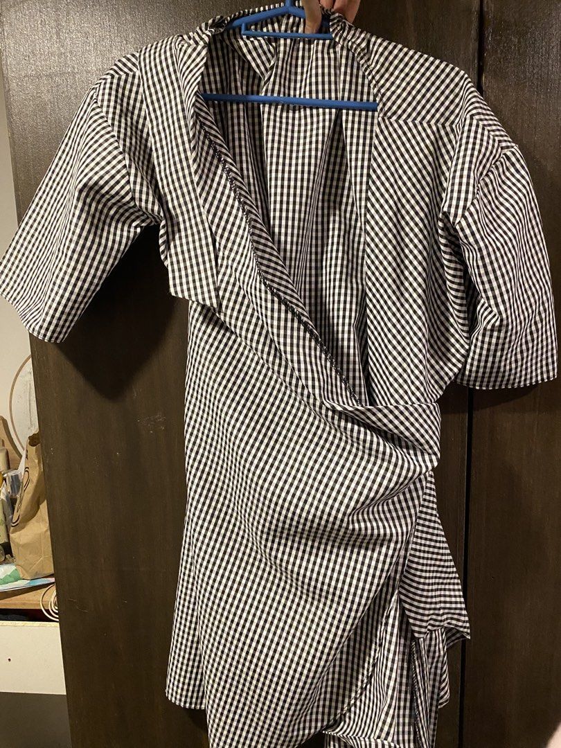 Black and White Gingham Wrap Dress (Category: Dresses) located in Manila. Submitted by hanzlopez (Listing ID 1463272097, Image 1). Description: - Adorable black and white gingham pattern - Flattering wrap dress style - Comfortable short sleeves - Chic side tie detail - Fabric with a beautiful drape - Easily dressed up or down - Ideal for casual outings or summer days.
