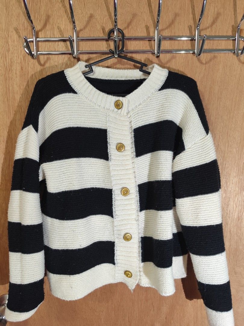Black and White Striped Button-Up Cardigan (Category: Coats, Jackets and Outerwear) located in Manila. Submitted by wisegem-c6c7 (Listing ID 1463185714, Image 1). Description: - Classic black and white striped knit cardigan - Features gold-tone buttons down the front - Crew neckline - Cozy and stylish design - Ideal for layering over tops or dresses - Versatile pairing with jeans or skirts.