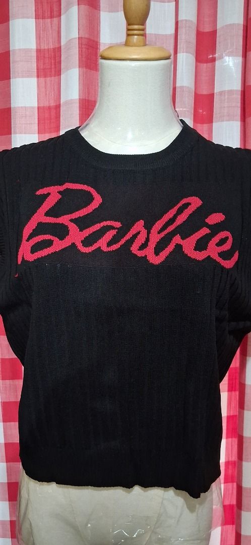 Black Barbie Sweater (Category: Longsleeves) located in Manila. Submitted by katkween23 (Listing ID 1463221719, Image 2). Description: - Iconic Barbie logo sweater in black - Features a bold red Barbie logo - Made from comfortable knitted material - Trendy cropped fit - Ideal for any Barbie enthusiast - Versatile styling with jeans or skirts - A fun and stylish wardrobe addition.