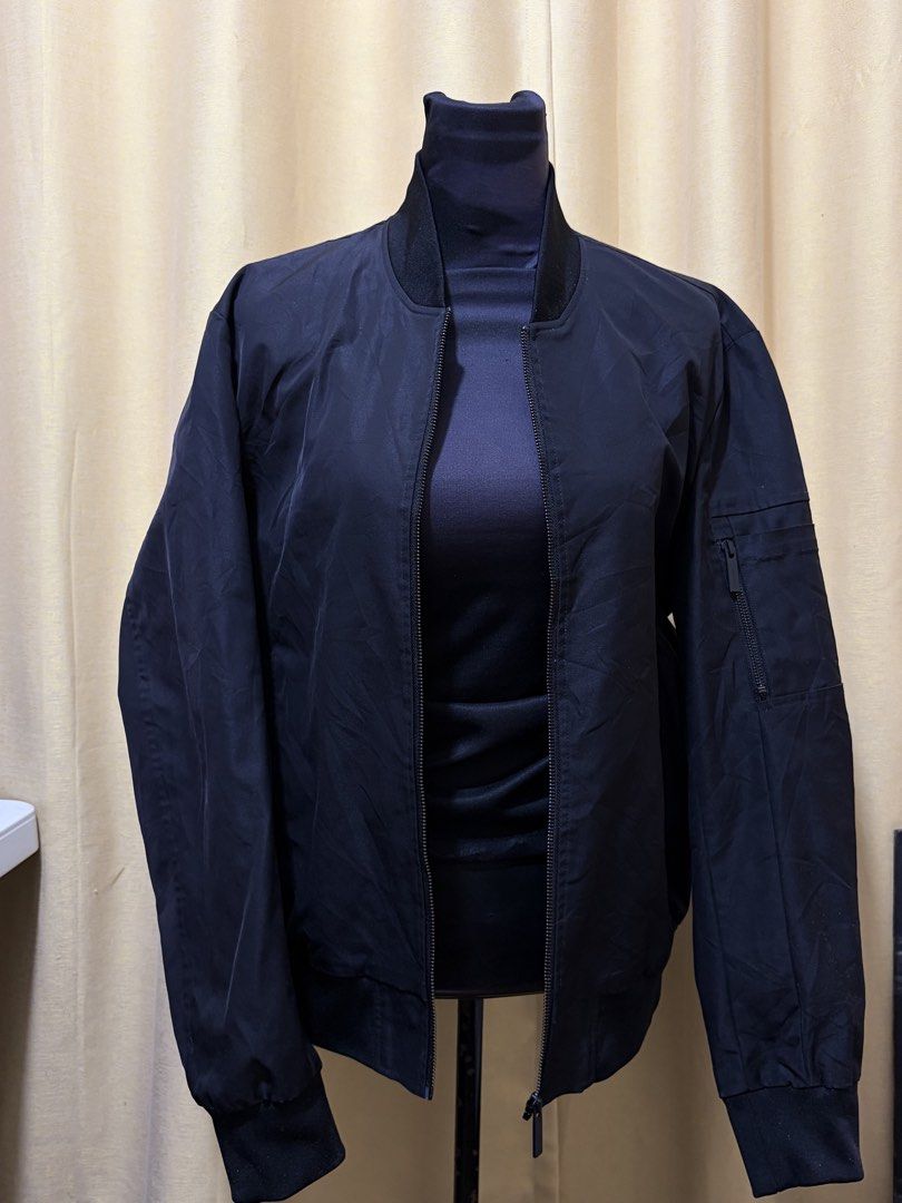 Black Bomber Jacket with Zipper Pockets (Category: Coats, Jackets and Outerwear) located in Baguio. Submitted by fionabanana (Listing ID 1463249424, Image 1). Description: - Classic black bomber jacket - Zipper closure down the front - Zippered pocket on the left sleeve - Ribbed collar, cuffs, and hem - Ideal for layering - Simple and versatile style.