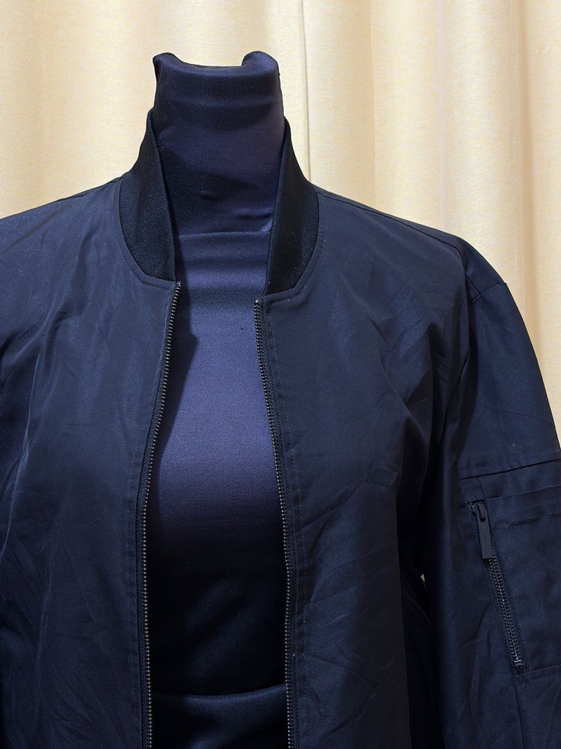 Black Bomber Jacket with Zipper Pockets (Category: Coats, Jackets and Outerwear) located in Baguio. Submitted by fionabanana (Listing ID 1463249424, Image 2). Description: - Classic black bomber jacket - Zipper closure down the front - Zippered pocket on the left sleeve - Ribbed collar, cuffs, and hem - Ideal for layering - Simple and versatile style.