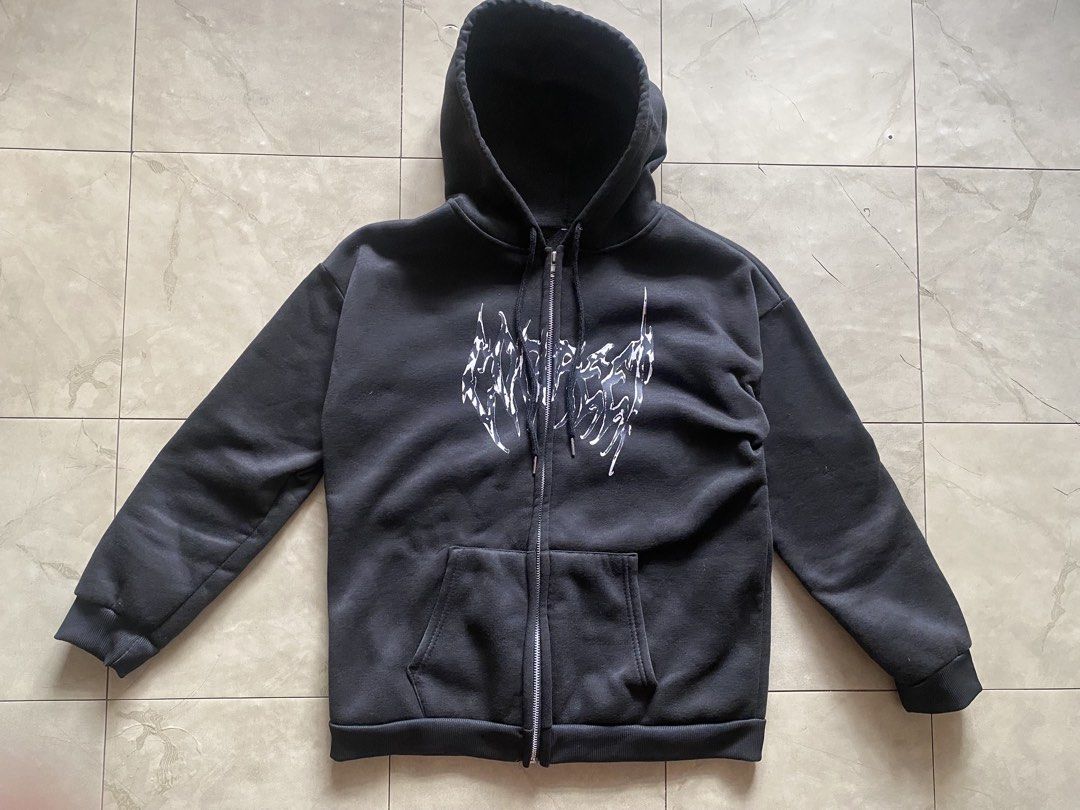 Black Butterfly Zip-Up Hoodie (Category: Coats, Jackets and Outerwear) located in Cabuyao City. Submitted by kekjct (Listing ID 1463240987, Image 1). Description: (Slightly Nego for Sure Buyers) Condition: 10/10 Size: 21” Pit-to-Pit × 25” Length (Regular / Slim Fit) Color: Washed Black / Charcoal Details: • Cybersigilism / tribal graphic print across chest • Full-zip front closure with silver metal zipper • Double front kangaroo pockets • Ribbed 