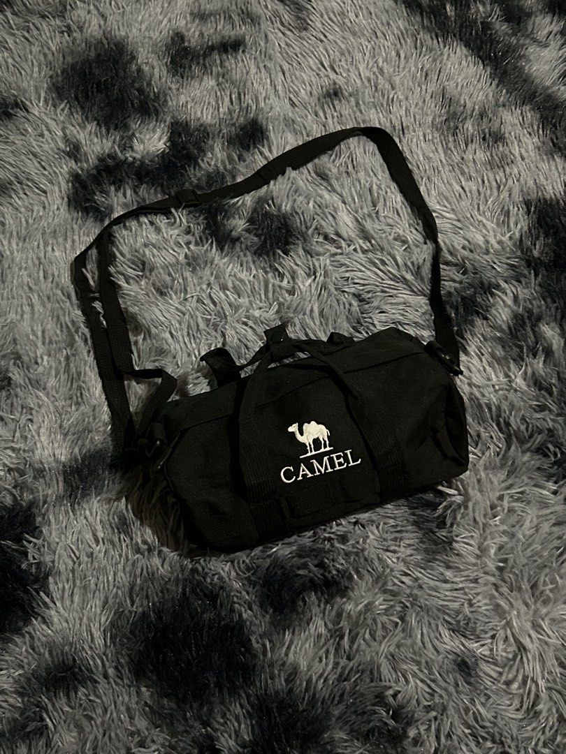 Black Camel Duffel Bag with Strap W11 L7 (Category: Sling Bags) located in Cadiz. Submitted by jaybatiller (Listing ID 1463256472, Image 1). Description: - Brand: Camel - Color: Black - Type: Duffel Bag - Features: Spacious main compartment, durable fabric - Carrying Options: Shoulder strap and two handles - Ideal for: Gym, short trips - Benefit: Easy to carry.