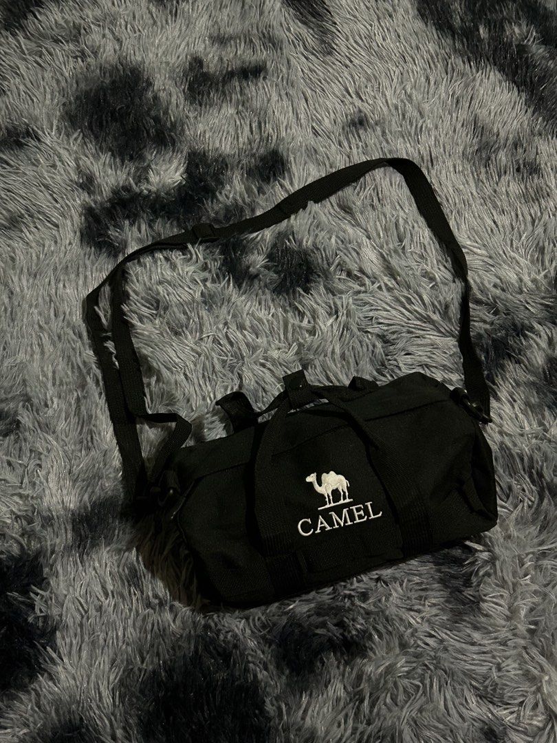 Black Camel Duffel Bag with Strap W11 L7 (Category: Sling Bags) located in Cadiz. Submitted by jaybatiller (Listing ID 1463256472, Image 2). Description: - Brand: Camel - Color: Black - Type: Duffel Bag - Features: Spacious main compartment, durable fabric - Carrying Options: Shoulder strap and two handles - Ideal for: Gym, short trips - Benefit: Easy to carry.