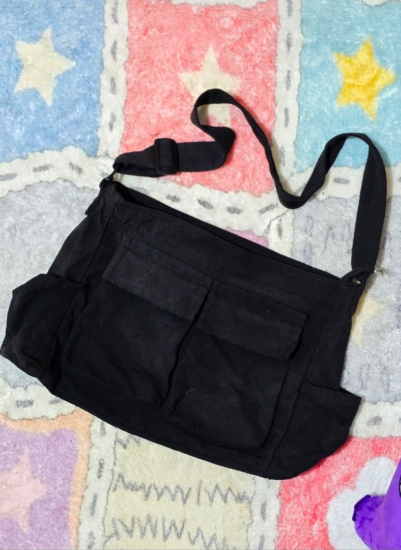 Black Canvas Crossbody Bag with Multiple Pockets (Category: Sling Bags) located in Paranaque City. Submitted by vanchris84 (Listing ID 1463264125, Image 2). Description: - Stylish black canvas crossbody bag - Zippered main compartment for secure storage - Two front pockets with convenient flaps - Additional side pockets for extra organization - Adjustable strap for a customized fit - Ideal for everyday use - Offers plenty of space for all your es