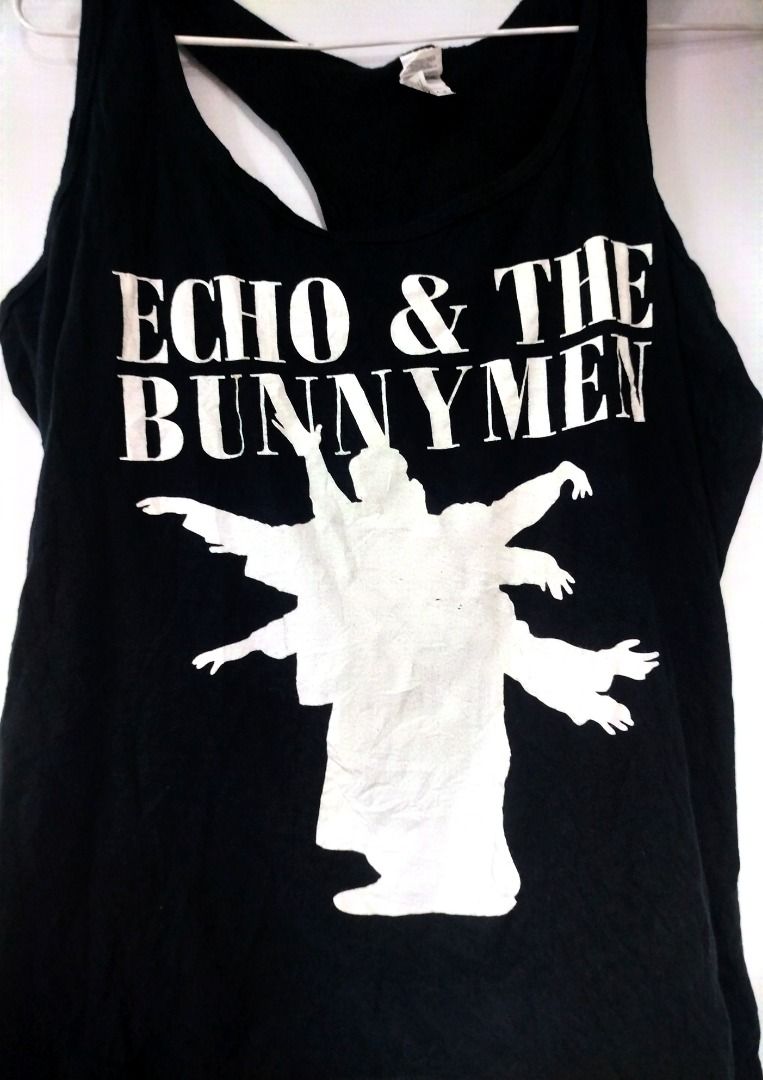 Black Echo & The Bunnymen Band Tank Top (Category: Sleeveless) located in Caloocan City. Submitted by safebear_4bdc70 (Listing ID 1463201435, Image 1). Description: - Black racerback tank top - Features Echo & The Bunnymen graphic print - Band name in white text above white silhouette - Comfortable and casual wear - Ideal for fans of the band.