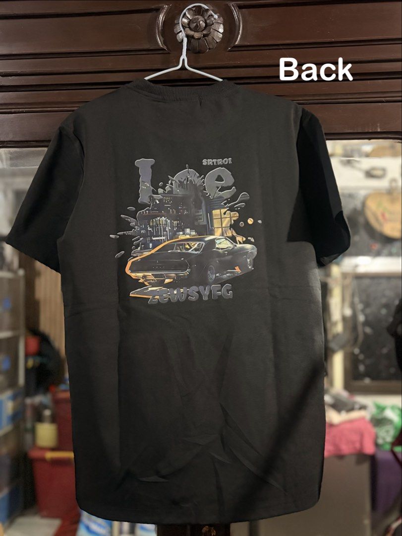 Black Graphic T-Shirt - Large (Category: Tshirts & Polo Shirts ) located in Manila. Submitted by trish.enna (Listing ID 1463233901, Image 2). Description: - Color: Black - Design: Cool graphic on the back featuring a car and abstract elements - Text on back: 'SRTRO1' and 'ZEWSYEG' - Size: Large (L) - Ideal for: Casual wear - Condition: Good.