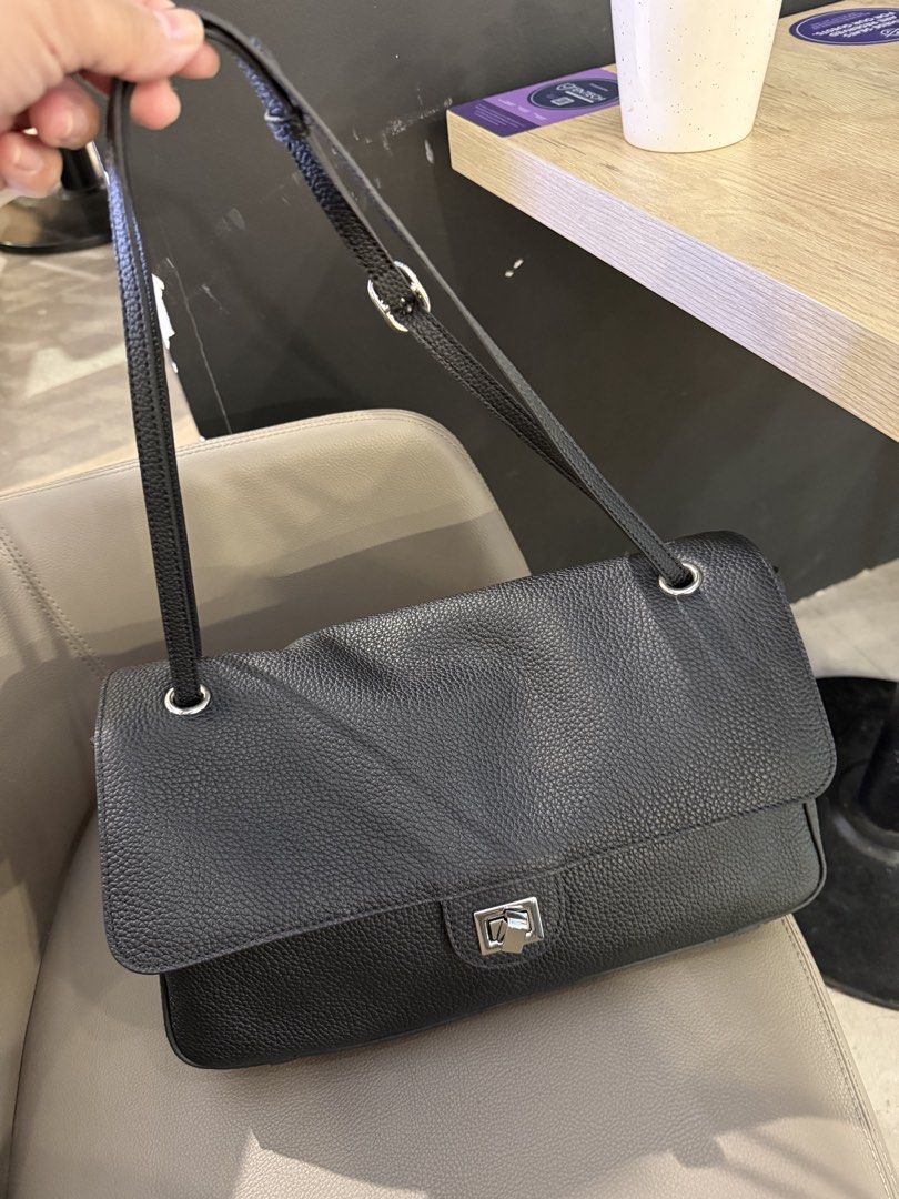 Black Leather Shoulder Bag with Silver Clasp (Category: Shoulder Bags) located in Makati City. Submitted by bns4acoz (Listing ID 1463270361, Image 2). Description: - Stylish black leather shoulder bag - Textured leather finish for a premium look - Secure silver clasp closure on the front flap - Long, adjustable strap for comfortable wear - C. Blazy inspired style - 36 cm base width - Genuine clemence leather - location QC - comes with dust bag, n