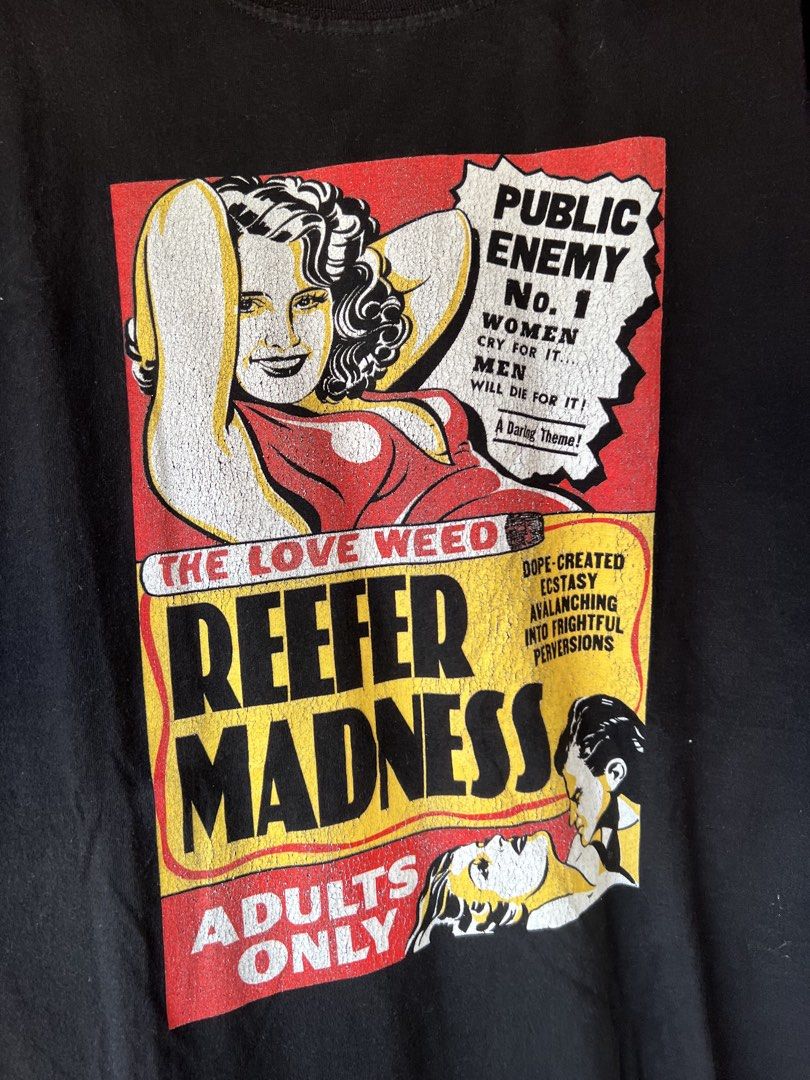 Black Reefer Madness T-shirt (Category: Tshirts & Polo Shirts ) located in Manila. Submitted by re-connectph888 (Listing ID 1463143347, Image 2). Description: - Black t-shirt - 'Reefer Madness' graphic print - Vintage movie poster style design - Bold text and illustrations - 'Adults Only' printed on front - Classic propaganda style graphic - Great conversation starter.