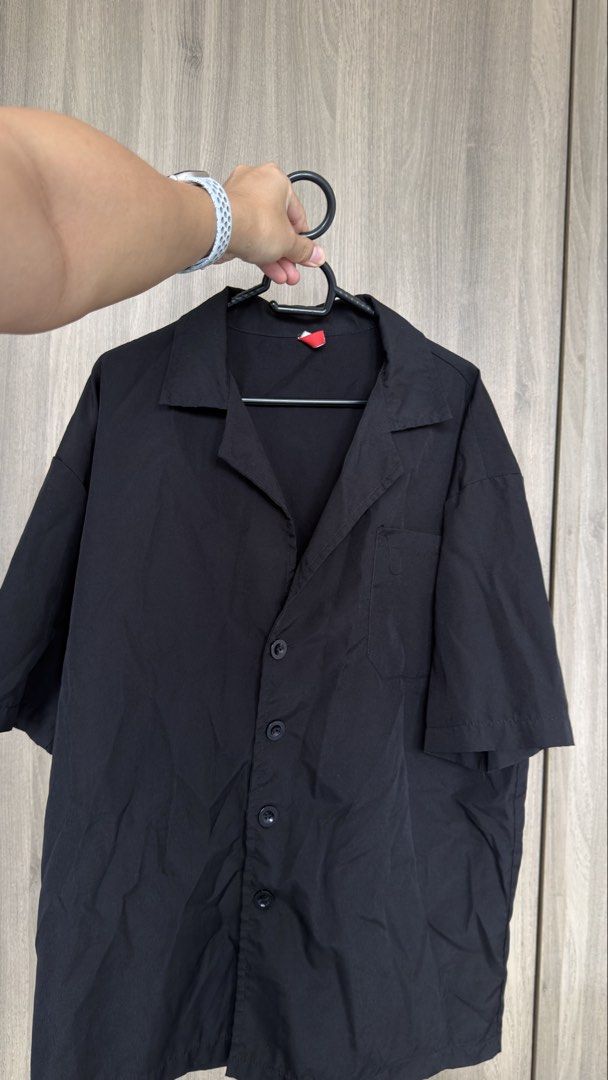 Black Short Sleeve Button Up Shirt (Category: Shirts) located in Manila. Submitted by jmbb00.03 (Listing ID 1463136725, Image 1). Description: - Black short sleeve shirt - Features a collar - Button-up front closure - Single chest pocket - Lightweight material - Ideal for casual outfits or layering.