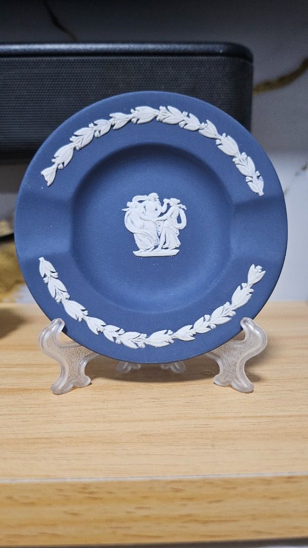 Blue Jasperware Ashtray with White Relief (Category: Other Home Decor) located in Manila. Submitted by auybiag (Listing ID 1463201912, Image 1). Description: - Vintage blue Jasperware ashtray - Classic white relief design of figures in the center - Laurel wreath border - Small indentations for cigarettes - Ideal for collectors or as a decorative piece - Display stand included.