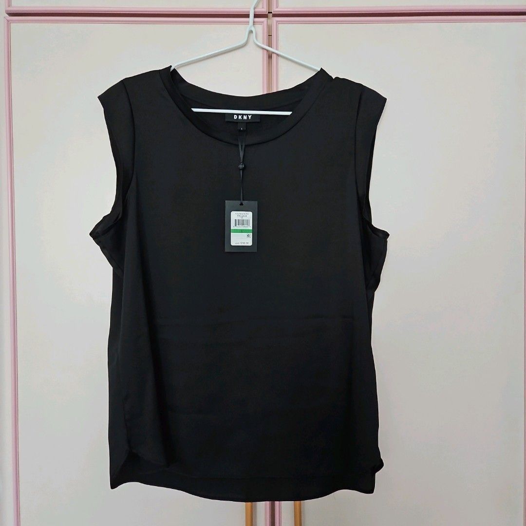 BN DKNY Black Sleeveless Top (Category: Sleeveless) located in Manila. Submitted by april_sixteen (Listing ID 1463190071, Image 2). Description: - Brand: DKNY - Color: Black - Style: Sleeveless top - Condition: Brand new with original tags attached - Design: Simple and classic - Versatility: Great for layering or wearing on its own - Wardrobe essential.