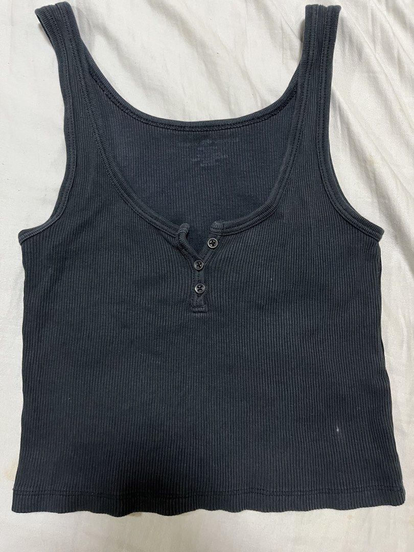 Brandy Melville Black Dalis Top (Category: Sleeveless) located in Makati City. Submitted by diannecheryl (Listing ID 1463209542, Image 1). Description: - Black ribbed tank top - Functional buttons down the front - Stretchy material for a comfortable fit - Versatile: great for layering or wearing on its own - Fits true to size.