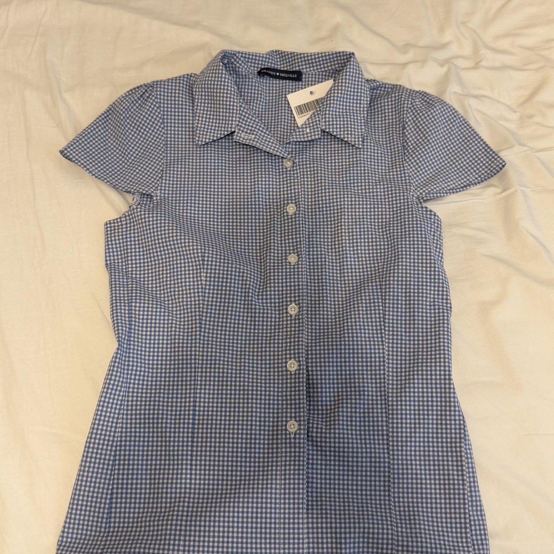 Brandy Melville Rue Blue Gingham Button Up Shirt (Category: Shirts) located in Vigan. Submitted by rainberry (Listing ID 1463160287, Image 3). Description: 15in width 21in length - 95% cotton, 5% elastane - blue gingham pattern .