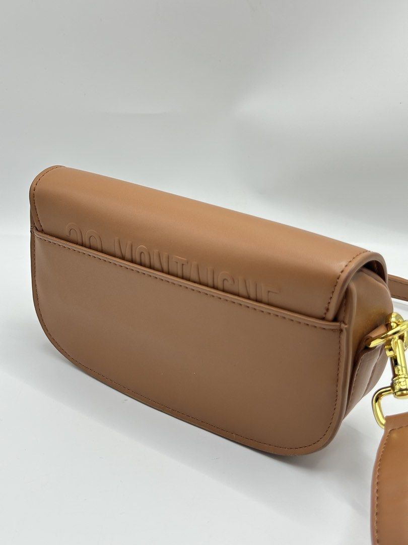 Brown Dior Saddle Bag CD Logo (Category: Luxury Bags & Wallets) located in Manila. Submitted by dough_lux (Listing ID 1463162816, Image 3). Description: - Stylish brown saddle bag - Features iconic gold CD logo hardware - Adjustable strap for comfortable wear - Embossed '30 MONTAIGNE' detail on the back flap - Small scuff mark present on the buckle strap - Ideal everyday bag.