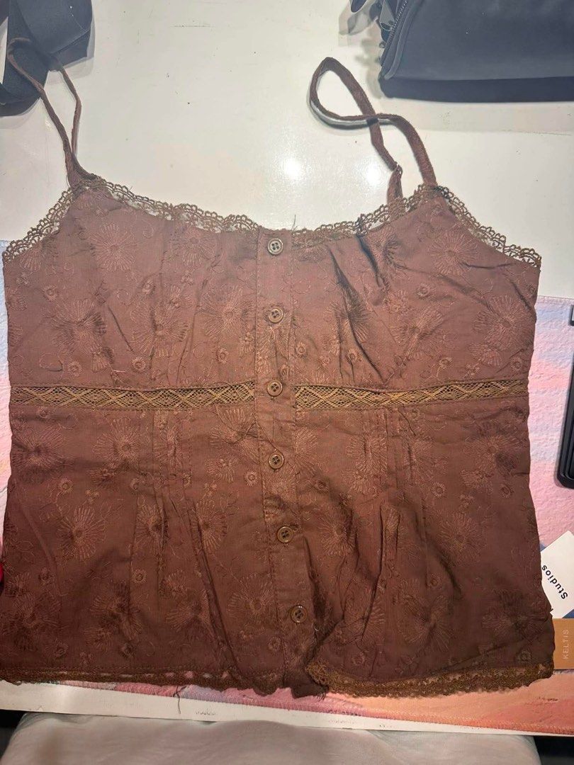 Brown Embroidered Lace Trim Cami Top (Category: Sleeveless) located in Talavera. Submitted by nicooolee (Listing ID 1463301861, Image 1). Description: - Cute brown cami top - Brand new, bought from Thailand - Floral embroidery detail - Lace trim on neckline and hem - Button-up front - Adjustable straps - Versatile: pairs well with jeans or skirts - Ideal for casual days or nights out.