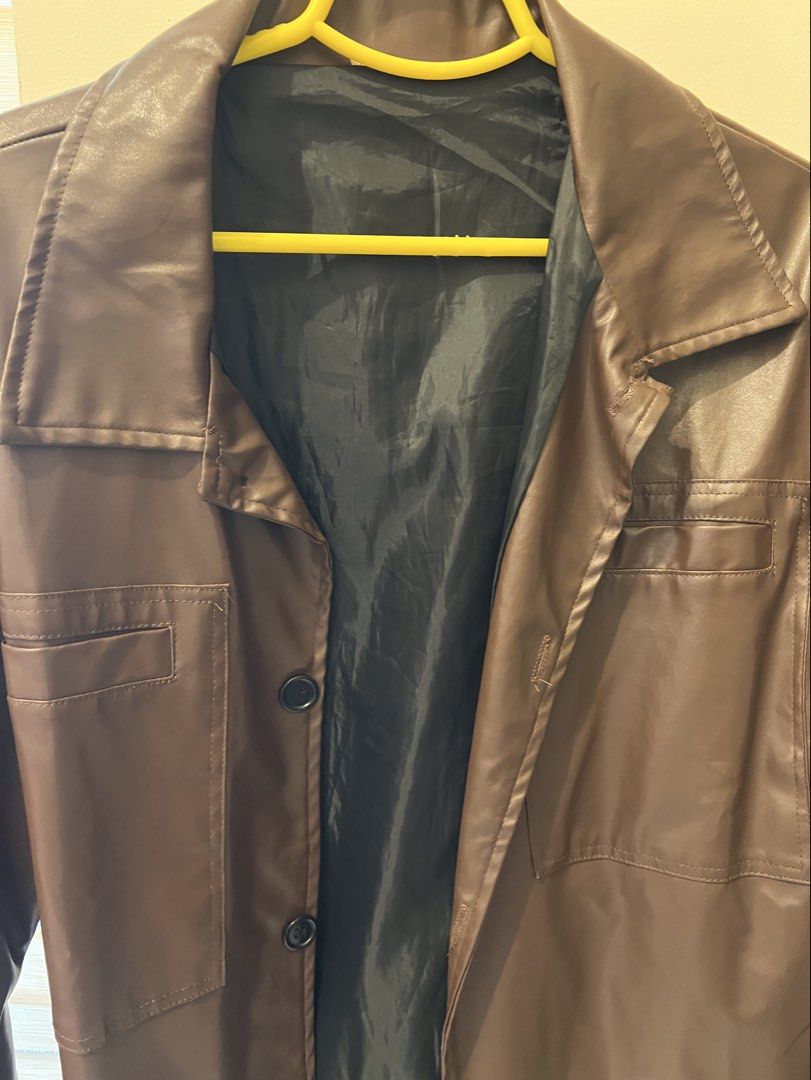 Brown Faux Leather Button-Up Jacket (Category: Coats, Jackets and Outerwear) located in Las Pinas. Submitted by basicapparel_mnl (Listing ID 1463198934, Image 2). Description: - Cool brown jacket - Faux leather look - Two chest pockets - Button front closure - Black lining - Ideal for layering - Versatile for casual or dressed-up styles.