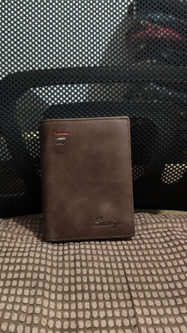 Brown Leather Bi-fold Wallet with Coin Compartment (Category: Wallets & Card holders) located in Taguig. Submitted by ceefam.online.shop (Listing ID 1463147463, Image 2). Description: - Genuine brown leather wallet - Clear ID window for easy access - Multiple card slots to organize your essentials - Secure zippered coin pocket - Subtle embossed brand name on front and inside - Classic, functional design.