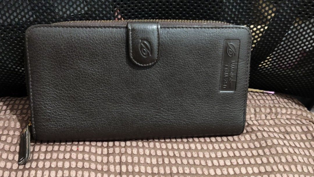 Brown Leather Wallet (Category: Wallets & Card holders) located in Taguig. Submitted by ceefam.online.shop (Listing ID 1463147874, Image 1). Description: - Genuine brown leather wallet - Secure snap closure - Convenient zip-around compartment - Ample card slots and pockets for organization - Zipper functions smoothly - Perfect for keeping your essentials tidy.
