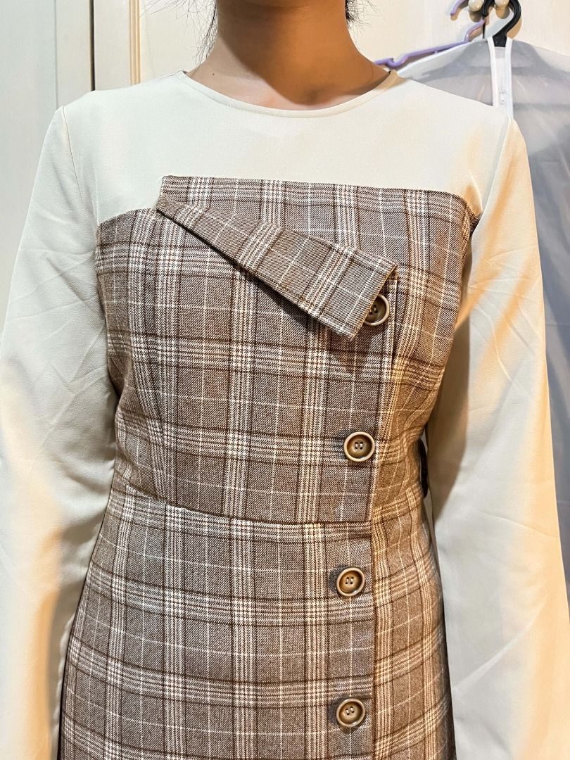 Brown Plaid Dress with Button Detail (Category: Dresses) located in Quezon City. Submitted by bunniezen (Listing ID 1463219396, Image 1). Description: - Classic brown plaid pattern - Contrasting cream top and sleeves - Versatile and stylish for any occasion.