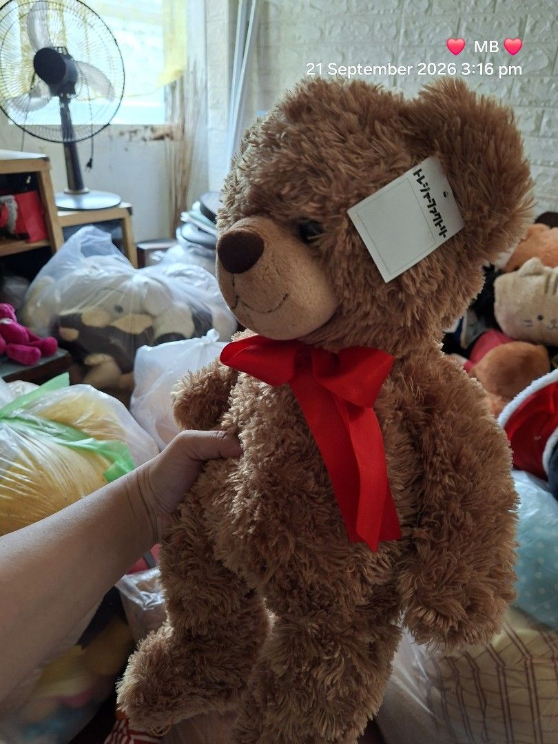 Brown Teddy Bear with Red Ribbon (Category: Plushies & Soft Toys) located in Lucena. Submitted by dai_suki (Listing ID 1463321787, Image 2). Description: - Adorable brown teddy bear - Fluffy and soft texture - Features a bright red ribbon around its neck - Perfect for hugging or as a decorative piece - Ideal gift for kids and teddy bear collectors - Cuddly and huggable.