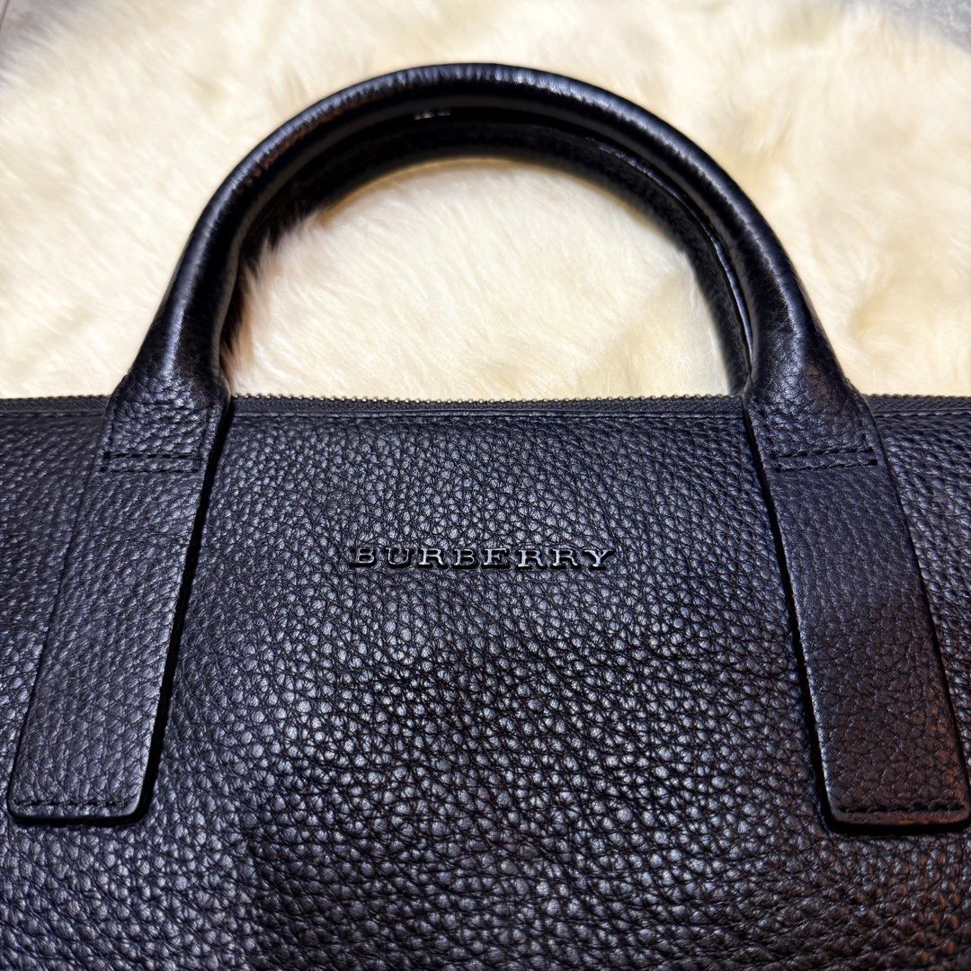 Burberry Laptop Bag (Category: Laptop Bags & Sleeves) located in Cainta. Submitted by shangitta (Listing ID 1463223702, Image 2). Description: Declutterring my work bags / laptop bags. Selling my Burberry black pebbled leather briefcase / laptop bag. Preloved and in good condition with normal signs of use. Leather, handles, interior and overall structure are still well maintained. 13” MacBook shown in photo for size reference. Plus it has multipl