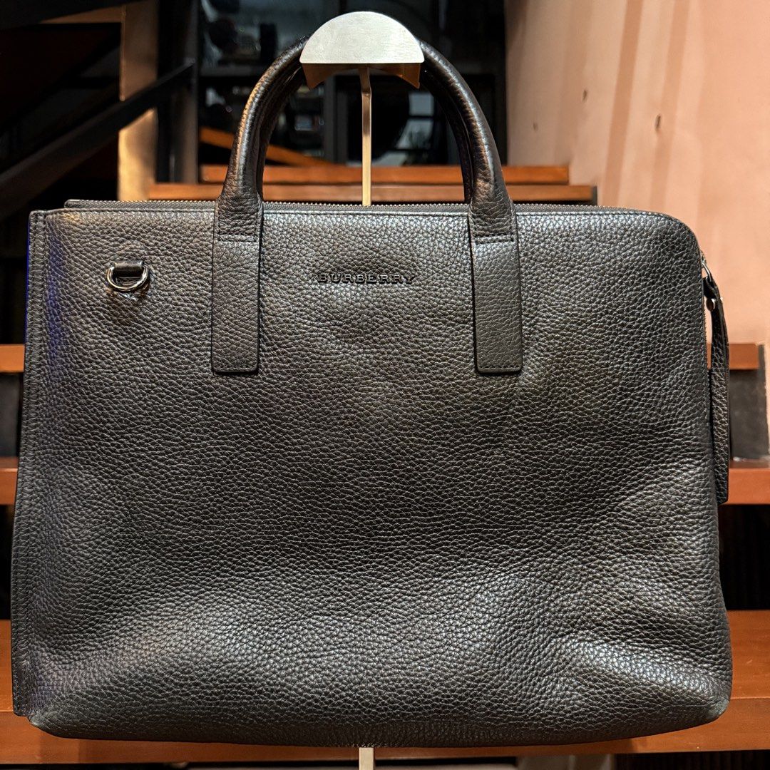 Burberry Laptop Bag (Category: Laptop Bags & Sleeves) located in Cainta. Submitted by shangitta (Listing ID 1463223702, Image 3). Description: Declutterring my work bags / laptop bags. Selling my Burberry black pebbled leather briefcase / laptop bag. Preloved and in good condition with normal signs of use. Leather, handles, interior and overall structure are still well maintained. 13” MacBook shown in photo for size reference. Plus it has multipl