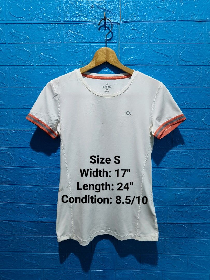 Calvin Klein Performance White T-shirt Size S (Category: Activewear) located in Davao. Submitted by vndrgd (Listing ID 1463119946, Image 1). Description: - White Calvin Klein Performance T-shirt - Size: S - Orange trim on sleeves and neckline - Measurements: 17" width, 24" length - Minor faint marks on front and near hem - Perfect for workouts or casual wear.