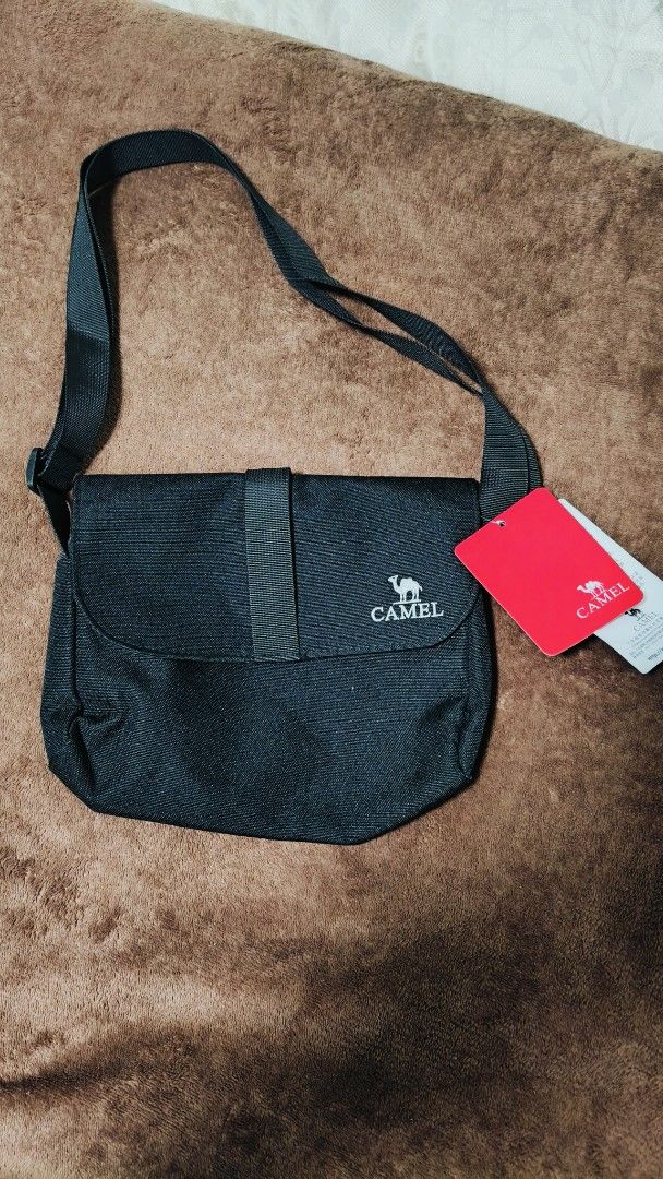 Camel Black Crossbody Bag with Tag (Category: Cross-body Bags) located in Manila. Submitted by serenitycarlylle (Listing ID 1463301439, Image 1). Description: - Brand new Camel crossbody bag - Original tags attached - Features Camel logo on front flap - Lined interior with small label - Adjustable strap for comfort - Ideal for everyday use.