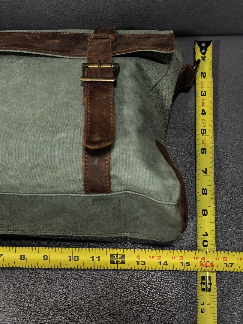 Canvas and Leather Messenger Bag (not filson) (Category: Luxury Bags & Wallets) located in Cagayan de Oro. Submitted by pootx (Listing ID 1463268906, Image 2). Description: - Durable green canvas messenger bag - Stylish brown leather accents - Main compartment with interior zippered pocket - Front flap with additional zippered pocket - Adjustable shoulder strap for comfort - Dimensions: Approximately 14 inches wide x 10 inches tall.