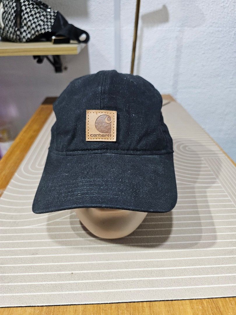 Carhartt cotton baseball cap (Category: Caps & Hats) located in Baguio. Submitted by kayeonlineshop (Listing ID 1463184544, Image 2). Description: -black Carhartt cotton baseball cap featuring a distinctive square tan leather logo patch on the front..