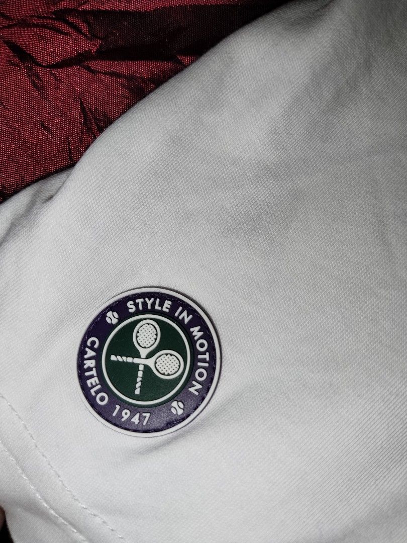 Cartelo Tennis Tee (Category: Tshirts & Polo Shirts ) located in Mabalacat. Submitted by al_amin_thrift (Listing ID 1463227836, Image 2). Description: - Brand: Cartelo — established 1947, premium casual wear ​ - Size: Large (175/96A) — regular comfortable fit ​ - Material: 100% Cotton — soft, breathable, cool on skin ​ - Design Details: ✅ Embroidered crocodile logo on left chest ✅ Red-green-white striped crew neck trim ✅ Tennis-themed patch on sl