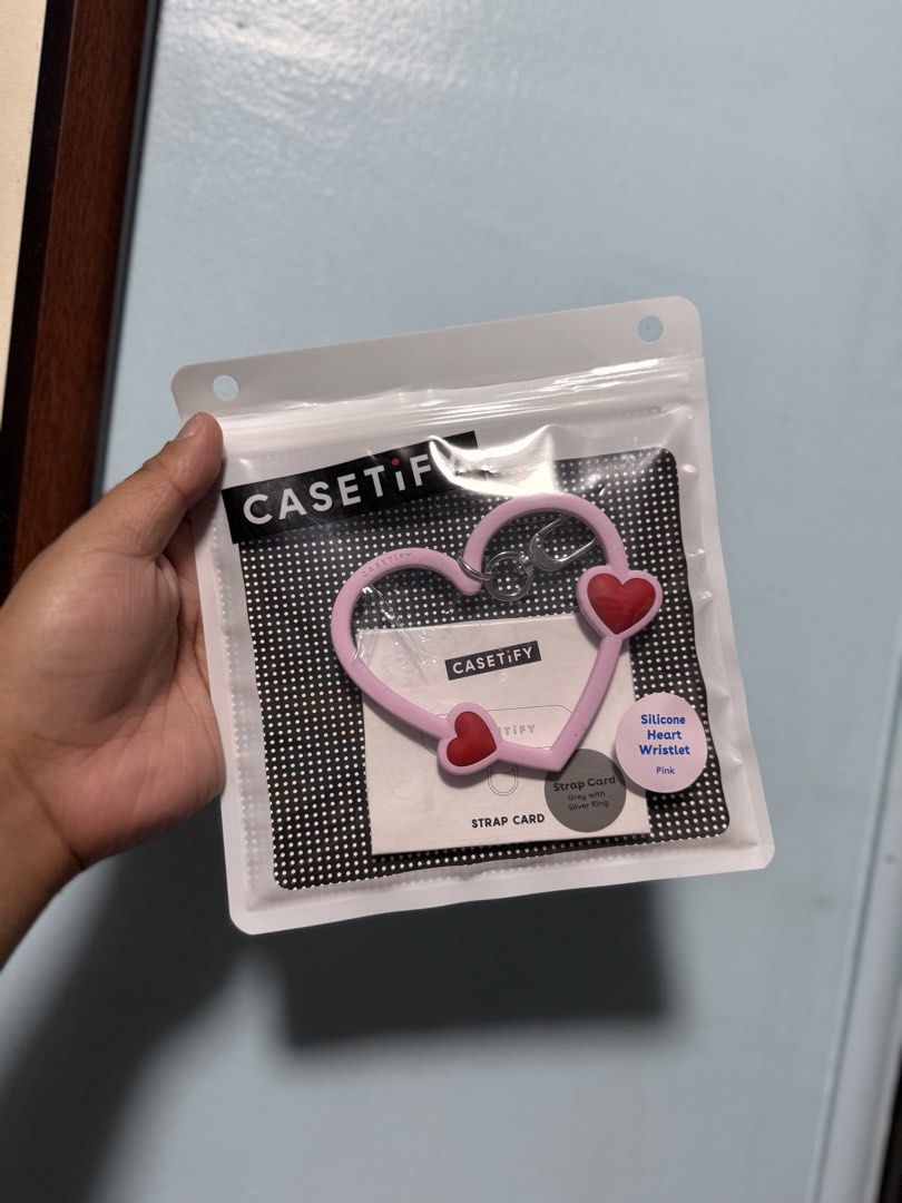 CASETiFY Silicone Heart Wristlet Pink (Category: Wallets & Card holders) located in Manila. Submitted by maema97 (Listing ID 1463271948, Image 1). Description: -CASETiFY heart wristlet - Includes grey strap card with silver ring - original packaging .